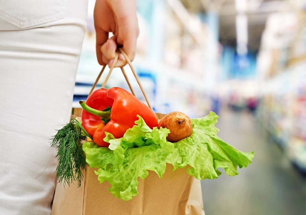 paper grocery bag with lettuce, herbs, pepper and potatoes